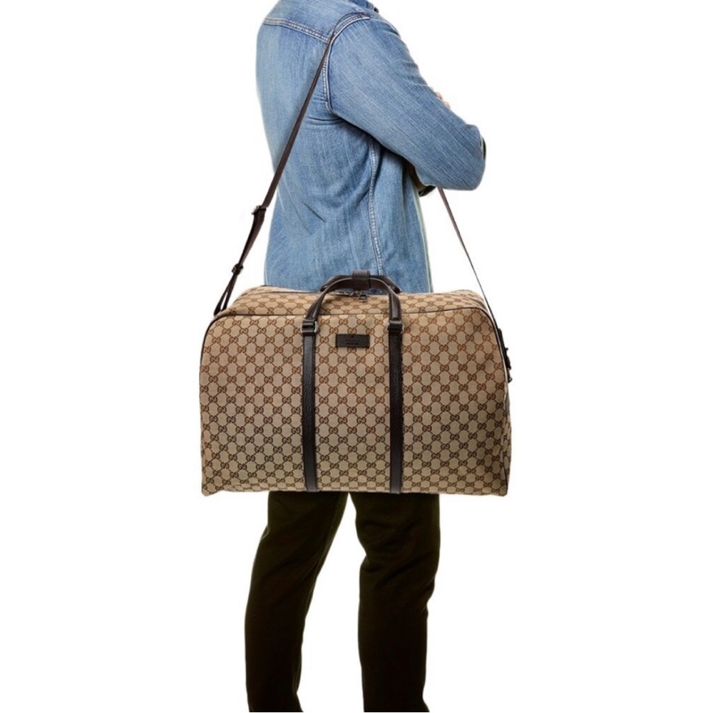 Gucci Duffle bag with strap.